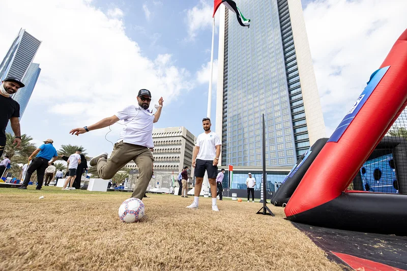 ADNOC employees posing in front of a UAE flag-inspired installation at the Jubilee event