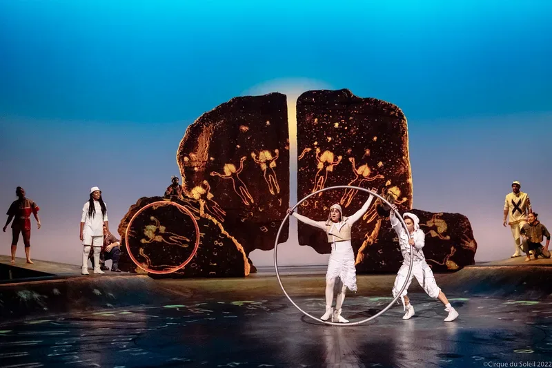 Cirque du Soleil Saudi National Day performance with Cyr wheel artists and scenic rock backdrop