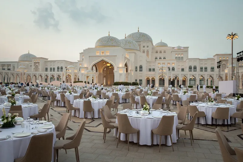 Large-scale outdoor gala dinner with premium event furniture and table settings