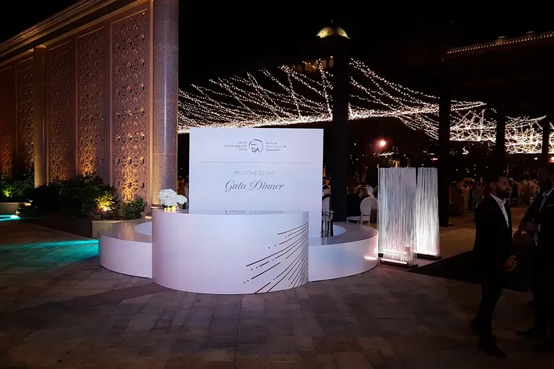 Outdoor event reception and hospitality area with custom branded counter