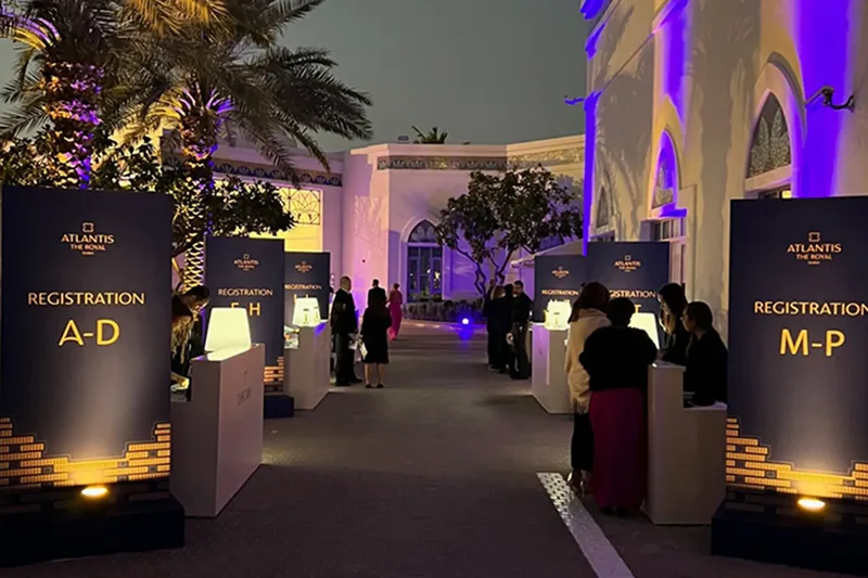 Outdoor evening corporate event with branded hospitality and lighting