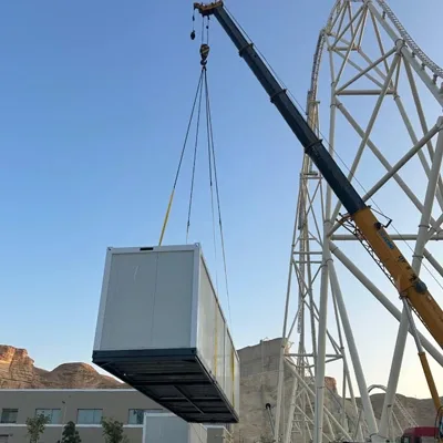 Crane installing large-scale temporary infrastructure for an event site