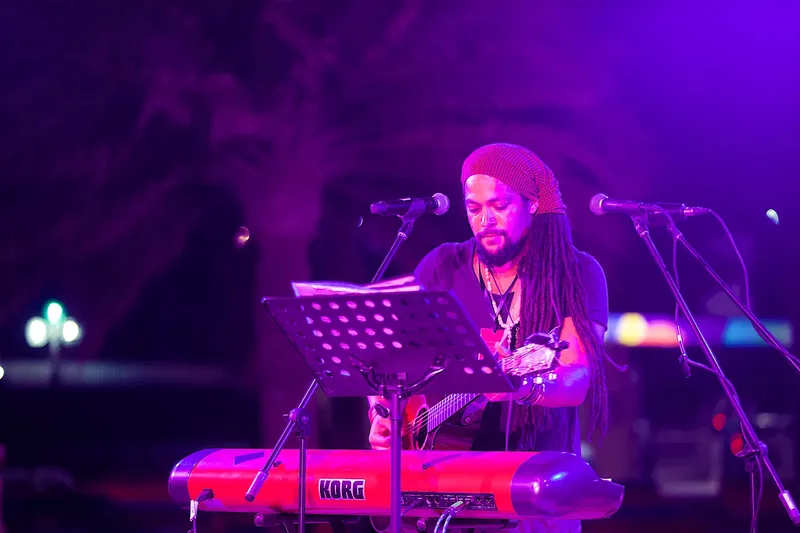Live musician performing keyboard and vocals at an event