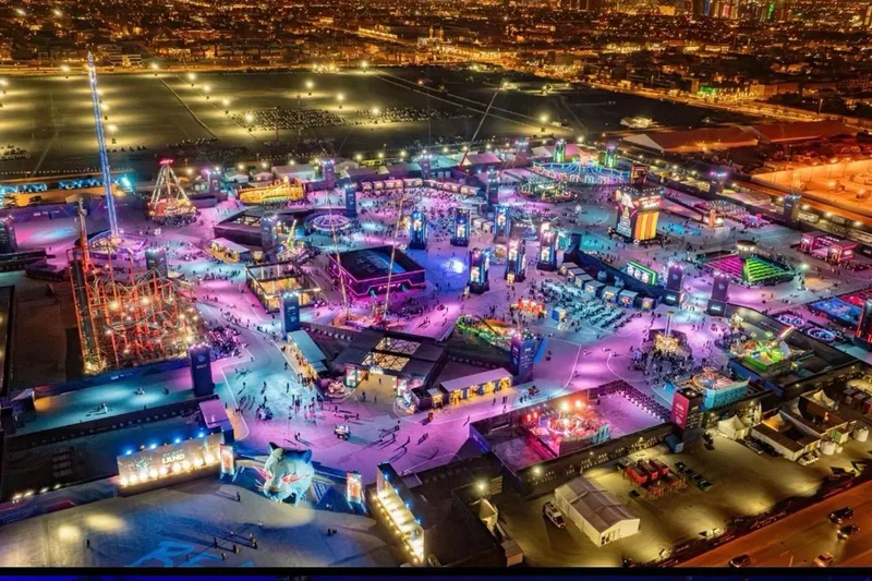 Large-scale outdoor festival with immersive lighting, attractions and event infrastructure